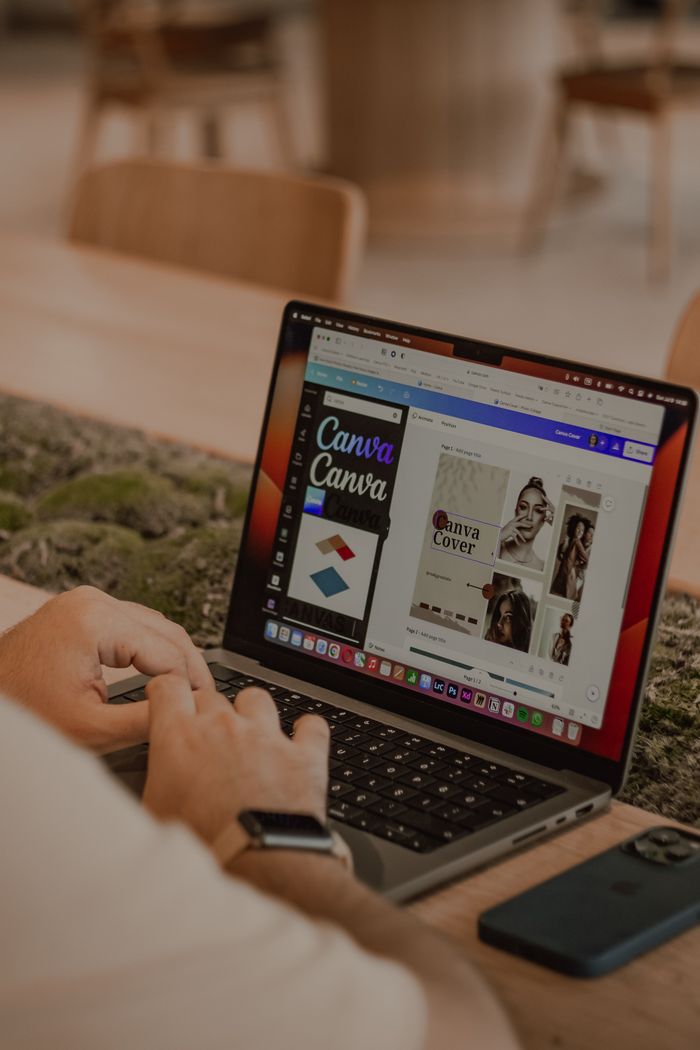 home-img Close-up of a person using a laptop to design with Canva.